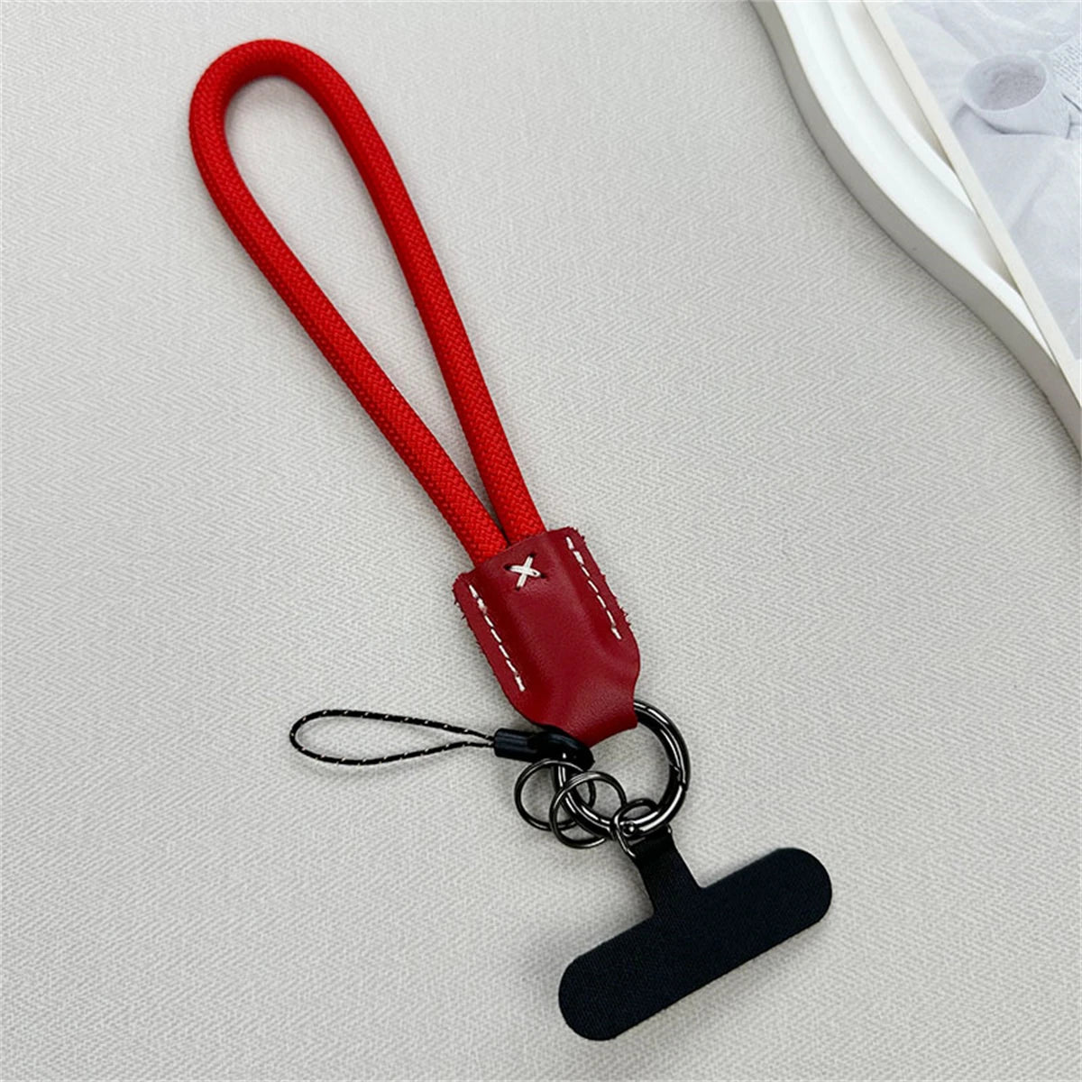 🎀 Lanyard Corto de Nylon y Cuero – Pulsera trenzada anticaídas con clip, cuerda decorativa para funda de celular